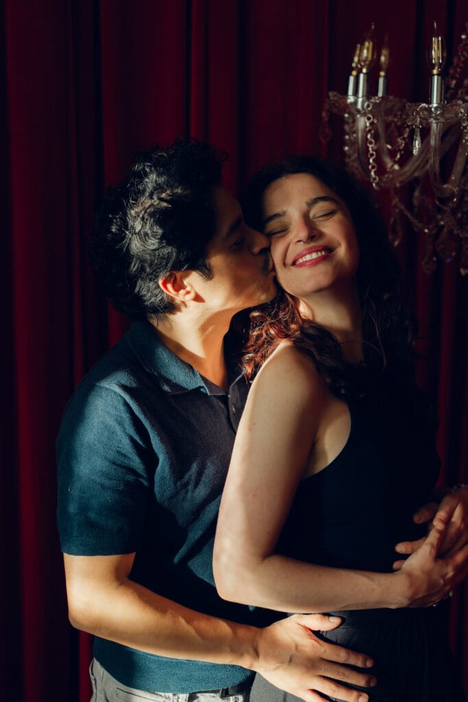Couple sharing a cheek kiss in warm light during a vintage romantic Valentine’s mini session at LA Loft Studios