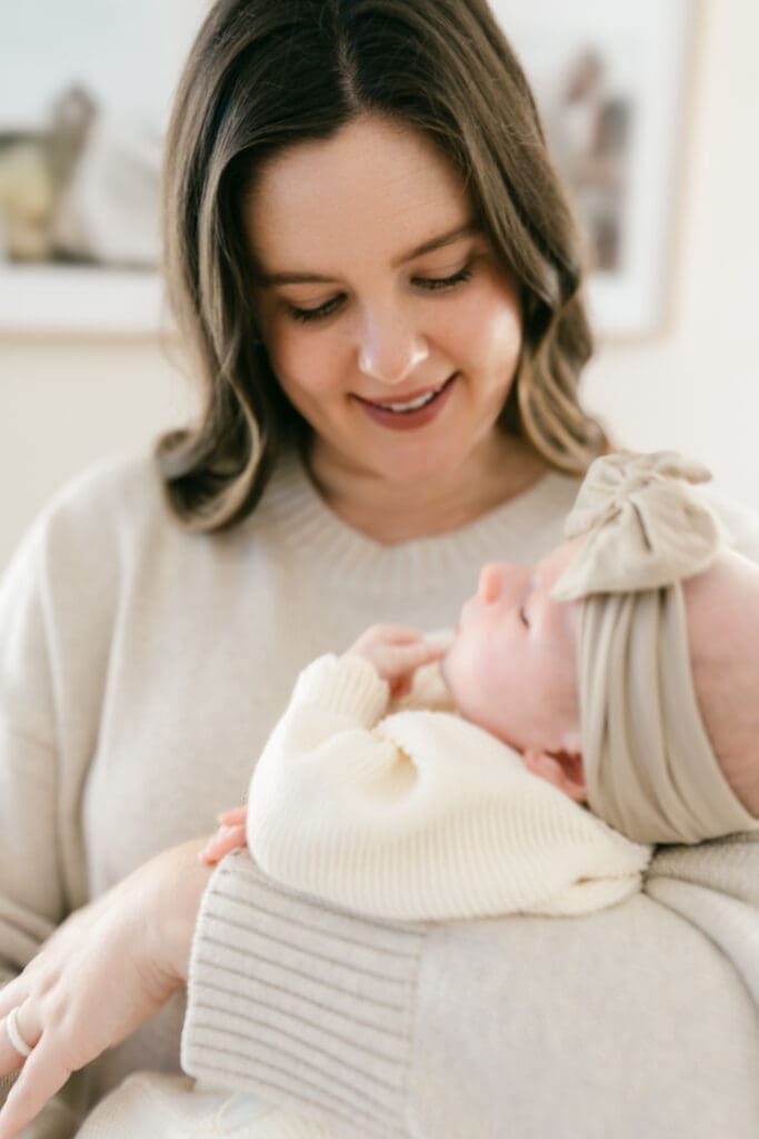 Mother gazing at her newborn daughter during an in-home lifestyle newborn photography session in Camarillo, California.